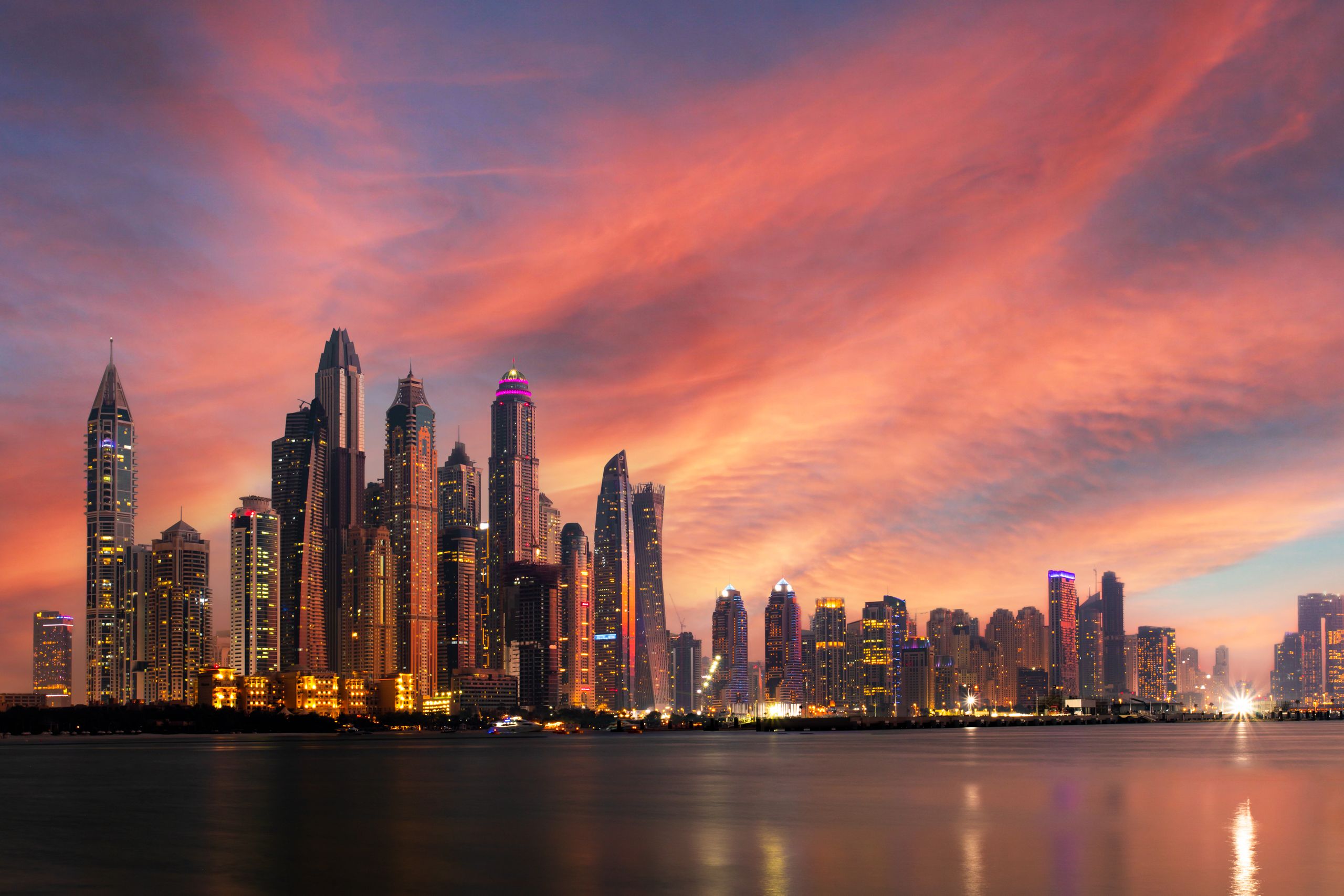 Dubai Marina skyline reflected in the waterfront at sunset